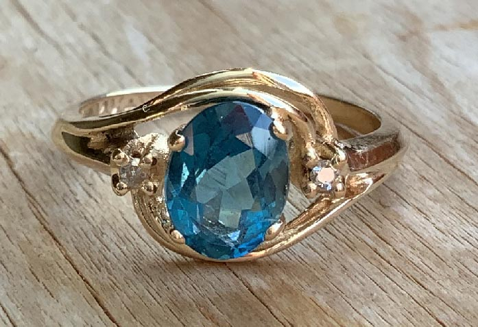 14ct Gold Swiss blue Topaz and Diamond ring that comes with a copy of a jewellers valuation for replacement cost of $1292
